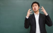 両手を上げて訴えかける講師